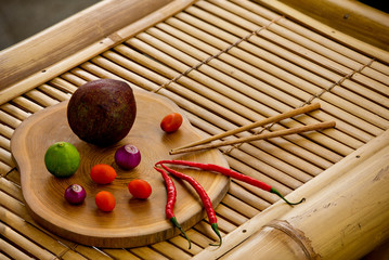 Fresh culinary ingredients for sauce guacamole on bamboo background.