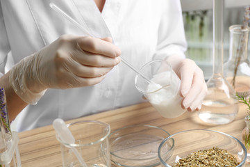 Scientist developing cosmetic product in laboratory, closeup