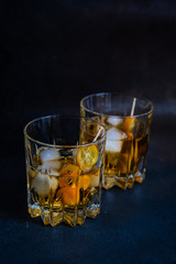 Whisky with ice and kumquat fruit