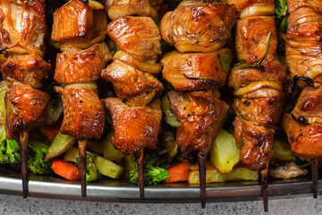 Appetizing, juicy turkey skewers on wooden skewers. Home cooking. Family dinner option. Homemade food.
