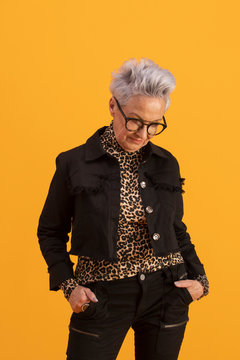 Portrait of stylish senior woman with short gray hair and eyeglasses