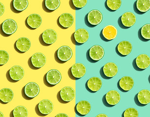 One out unique lemon surrounded by limes - flat lay