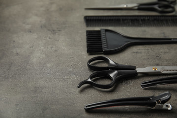Professional tools for hair dyeing on grey stone background, space for text
