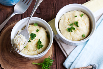 Dietary souffle of minced meat with parsley on a dark background.