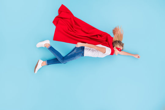 Top above high angle view profile side view full length photo positive super girl fly lay air raise hands save world fright evil characters wear white denim isolated blue color background