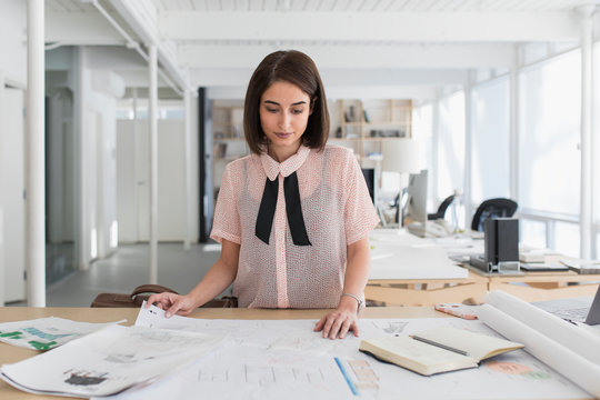 Woman looking at designs in creative agency