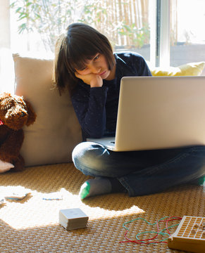 lonely child with computer bored by pandemic lockdown, virus quarantine