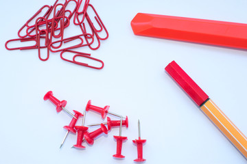 Office supplies in red on a white background, plain photo with free space for text