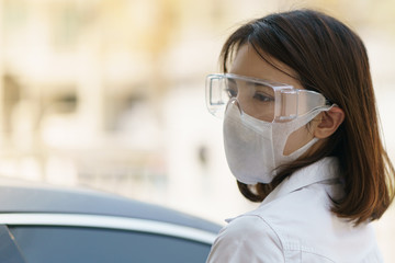 Woman wearing safety glasses and mask, to avoid the spread of coronavirus.