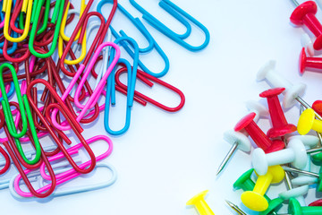 Stationery paper clips on a white background, photographed from above