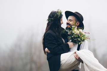 gorgeous bride and stylish groom, boho wedding couple, luxury ceremony at mountains with amazing view, space for text © Ananass