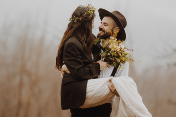 stylish young couple of brides photographed outdoors in the mountains