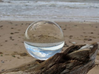 Fototapeta na wymiar Crystal ball on driftwood
