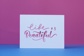 A lettering poster with a text that says life is beautiful