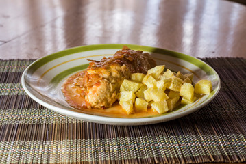 chicken chops stuffed with ham and cheese tomato sauce and french fries
