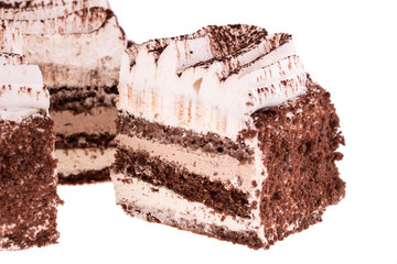 Piece of tiramisu with grated chocolate and air cream on white background