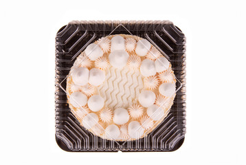Cream cake with vanilla cream in package

