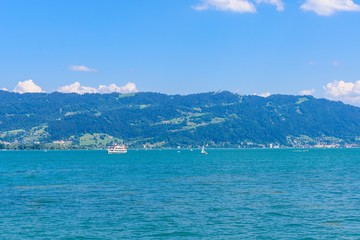 Fototapeta premium View on Bodensee lake Constance, from harbor in Lindau island, alps mountains. Baden-Wurttemberg Germany.