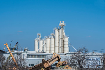 Cement silo tanks as industrial landscape in clear sunny day © varbenov