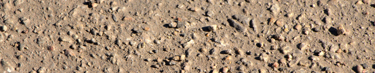 Background of asphalt on the screen saver. Texture of small stones, road surface.