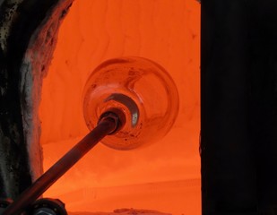 Fototapeta na wymiar Glass blowing in furnace