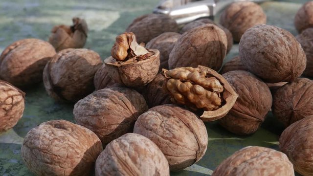 Edible seed of drupe walnut. Kernels and whole walnuts. Healthy snack food on rustic green old wooden table