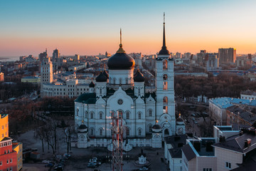 Fototapeta premium Evening Voronezh cityscape. Tower of management of south-east railway and Annunciation Cathedral at sunset background