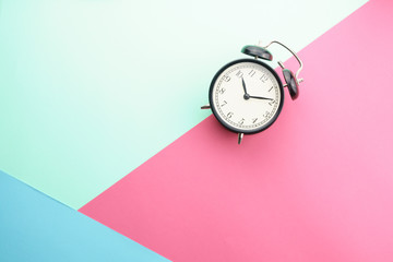 flat lay of alarm clock gainst color background. copy space for your text