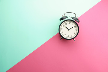 flat lay of alarm clock gainst color background. copy space for your text