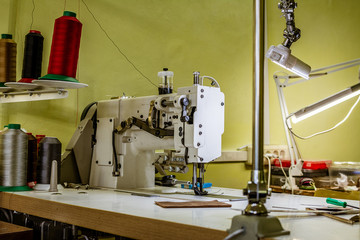 professional production sewing machine close-up, leather production, seamstress, tailor