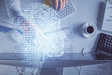 Double exposure of man's hands typing over computer keyboard and brain hologram drawing. Top view. Ai and data technology concept.