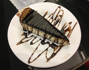 Delicious chocolate-covered Dutch cream pie with cookies and chocolate syrup on top. Sweet Dutch...