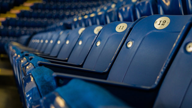 Empty rows of blue stadium seats 