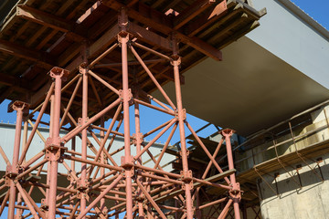 Obraz premium Scaffolding Elements Construction. Metal scaffolding tubes and bars. Construction site details. Bridge support. Industrial background.