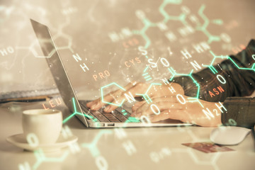 Fototapeta premium Double exposure of woman hands typing on computer and formula hologram drawing. Education concept.