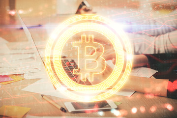 Double exposure of woman hands typing on computer and crypto market theme hologram drawing....