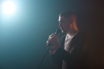 Young male singer on stage