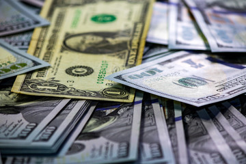 One old dollar bill on background made with one hundred dollar banknotes