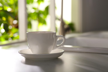 Cup of delicious coffee on kitchen countertop, space for text. Good morning