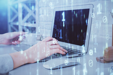 Double exposure of woman hands working on computer and data theme hologram drawing. Tech concept.