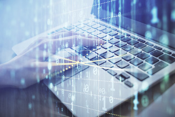 Double exposure of woman hands working on computer and data theme hologram drawing. Tech concept.