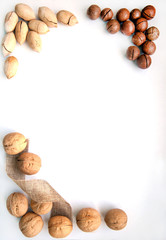 nuts in their shells on a white wooden background