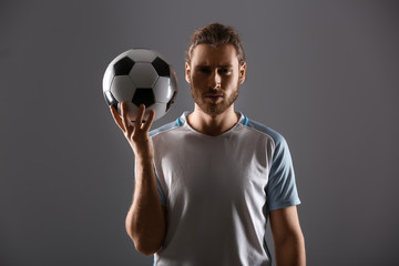 Silhouette of male football player on dark background