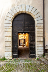 Beautiful old architecture in Cingoli, Marche Region, Province of Macerata, Italy, street arch entrance to an old building with fountain