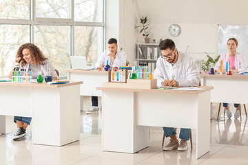 Young people at chemistry lesson in classroom