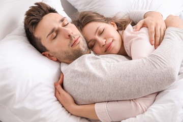 Young couple sleeping in bed