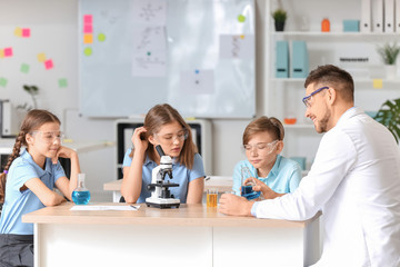 Teacher conducting chemistry lesson in classroom