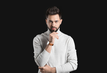 Handsome man with healthy hair on dark background