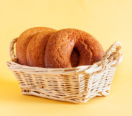 HOMEMADE DONUTS ON A WICKER BASKET AND A YELLOW BACKGROUND