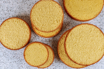 Sliced butter cake on table for making wedding cake.